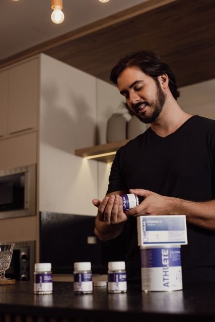 How Much Pre-Workout Should You Take? A Safer Guide to Serving Size, Caffeine, and Scoop Amount 3 Man examining the label on a supplement bottle