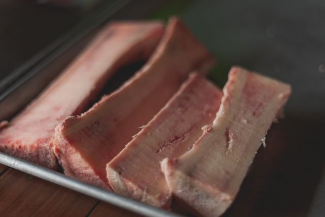 Raw beef bones and vegetables prepared for broth