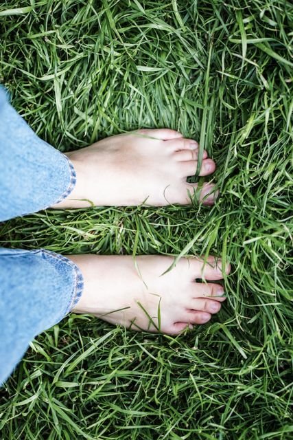 The Science of Earthing: What Grounding Does to Body Voltage—and What It Hasn’t Proven 2 Bare feet resting directly on green grass