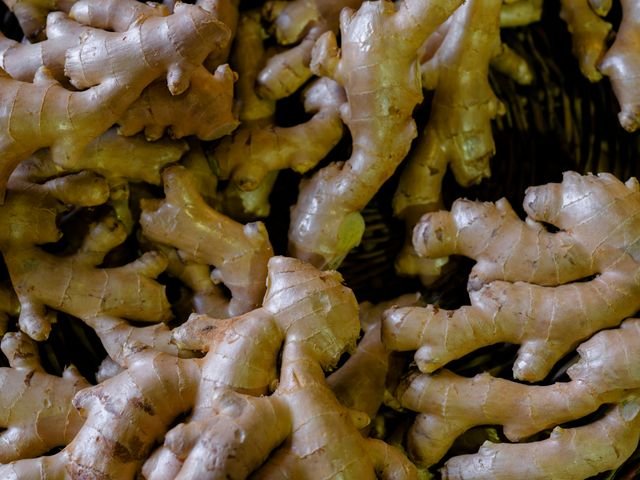 Close-up pile of fresh ginger roots at a market