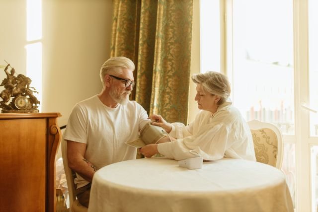 The Science of Earthing: What Grounding Does to Body Voltage—and What It Hasn’t Proven 4 Older adults using a blood pressure cuff and digital monitor