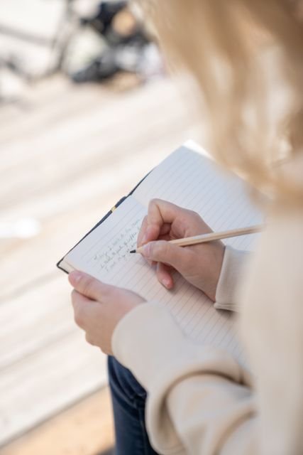 30-Day Gratitude Challenge: A Practical, Evidence-Based Plan to Build the Habit 3 Person writing reflections in a lined notebook outdoors