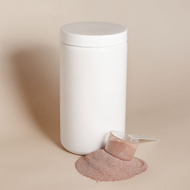 Unlabeled white supplement container with protein powder and scoop
