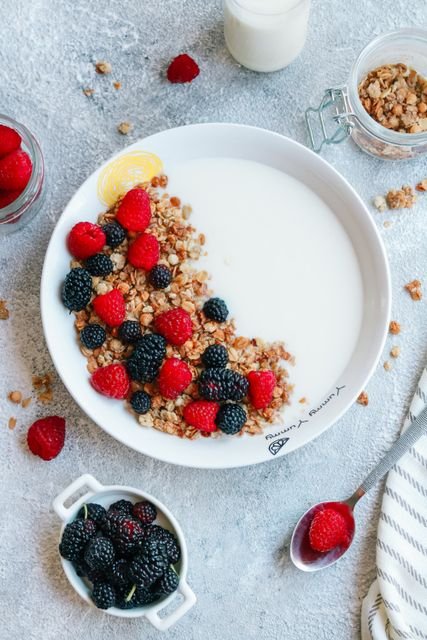 Yogurt bowl topped with granola and fresh berries
