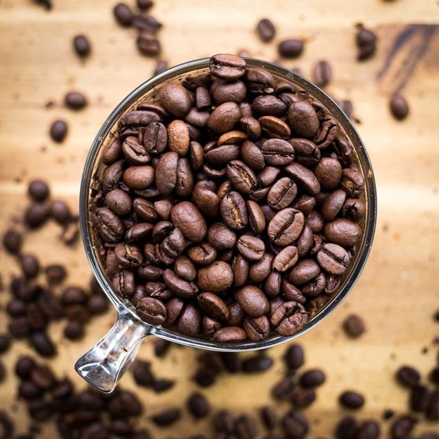 Matcha vs Coffee: Caffeine, Energy, Health Effects, Cost, and Which Fits You Better 6 Roasted coffee beans in a transparent cup